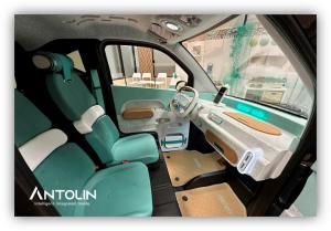 Interior de un vehículo con asientos y paneles en tonos verdes, fabricados con materiales sostenibles y diseño moderno.